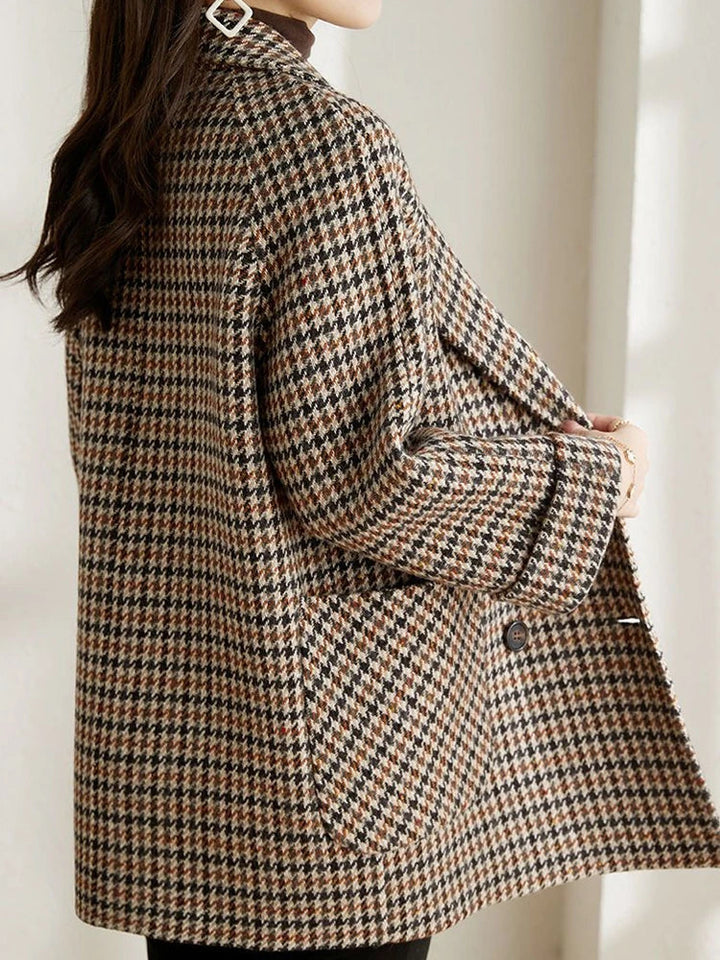 Close-up of a women's plaid blazer jacket, highlighting the spring-ready pattern and quality fabric.