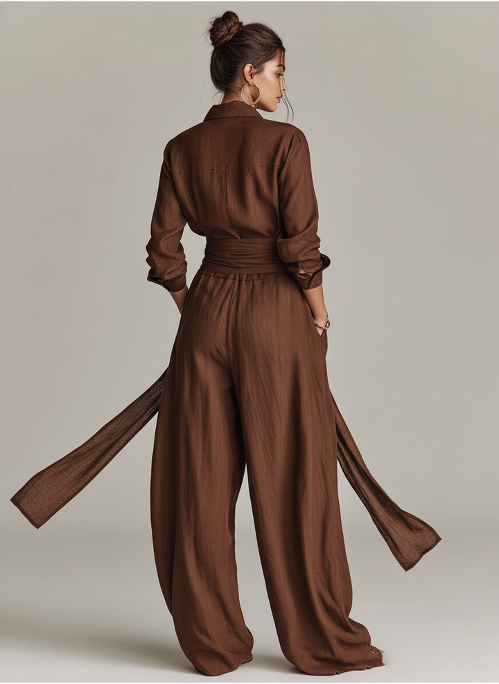 Women's long sleeve wide leg jumpsuit with adjustable tie waist, offering a flattering and comfortable fit.