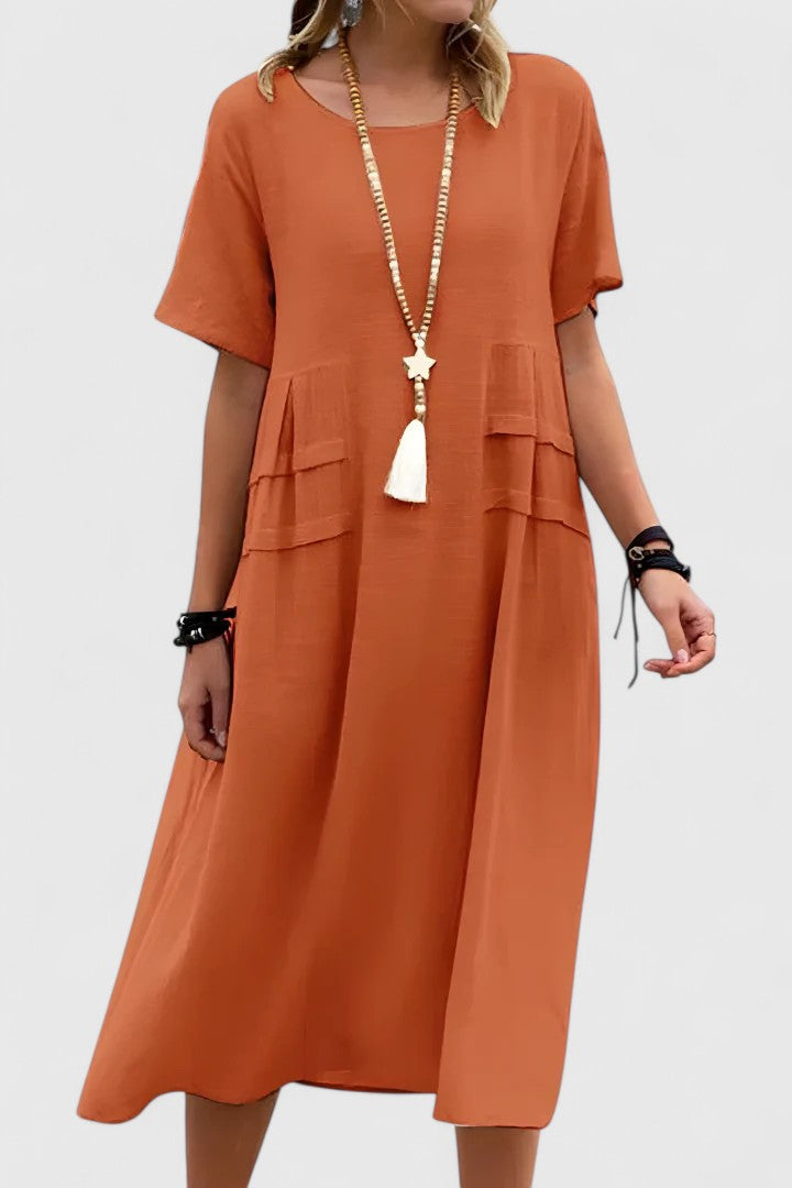 Women's loose fit midi dress with practical pockets, short sleeves. Comfortable casual summer style for everyday wear.