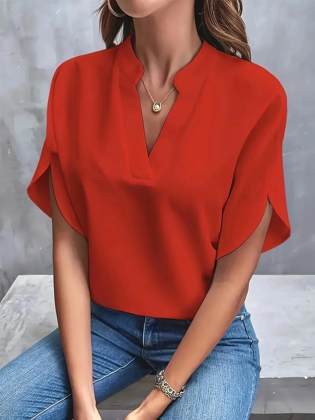 Stylish women's loose fit V-neck blouse with short sleeves, offering comfort and modern style.