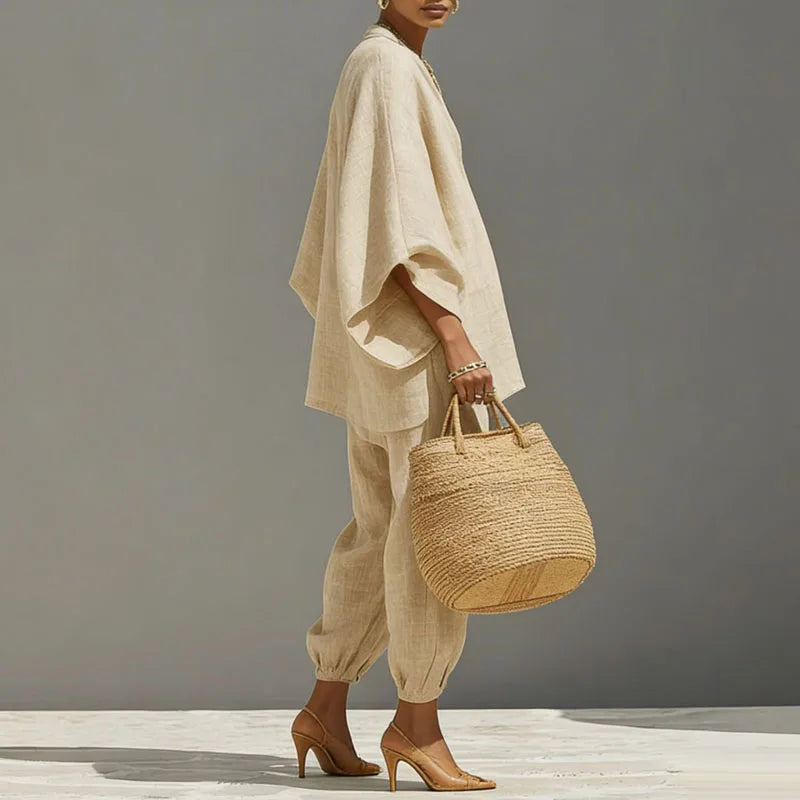Stylish women's linen blend two-piece set in apricot, with loose batwing top & tapered pants for resort wear.