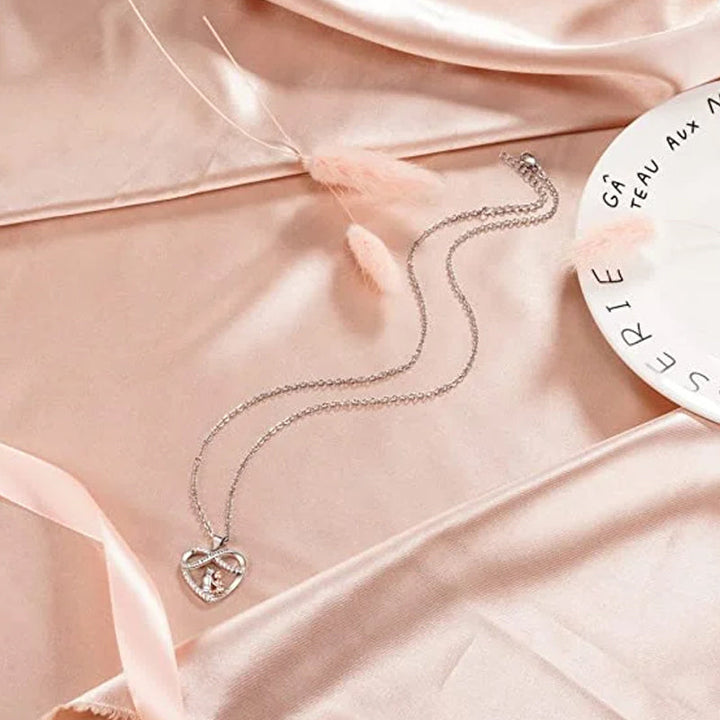 Close-up of heart pendant necklace, 'Love You Forever' engraving, delicate silver chain, ideal for granddaughters