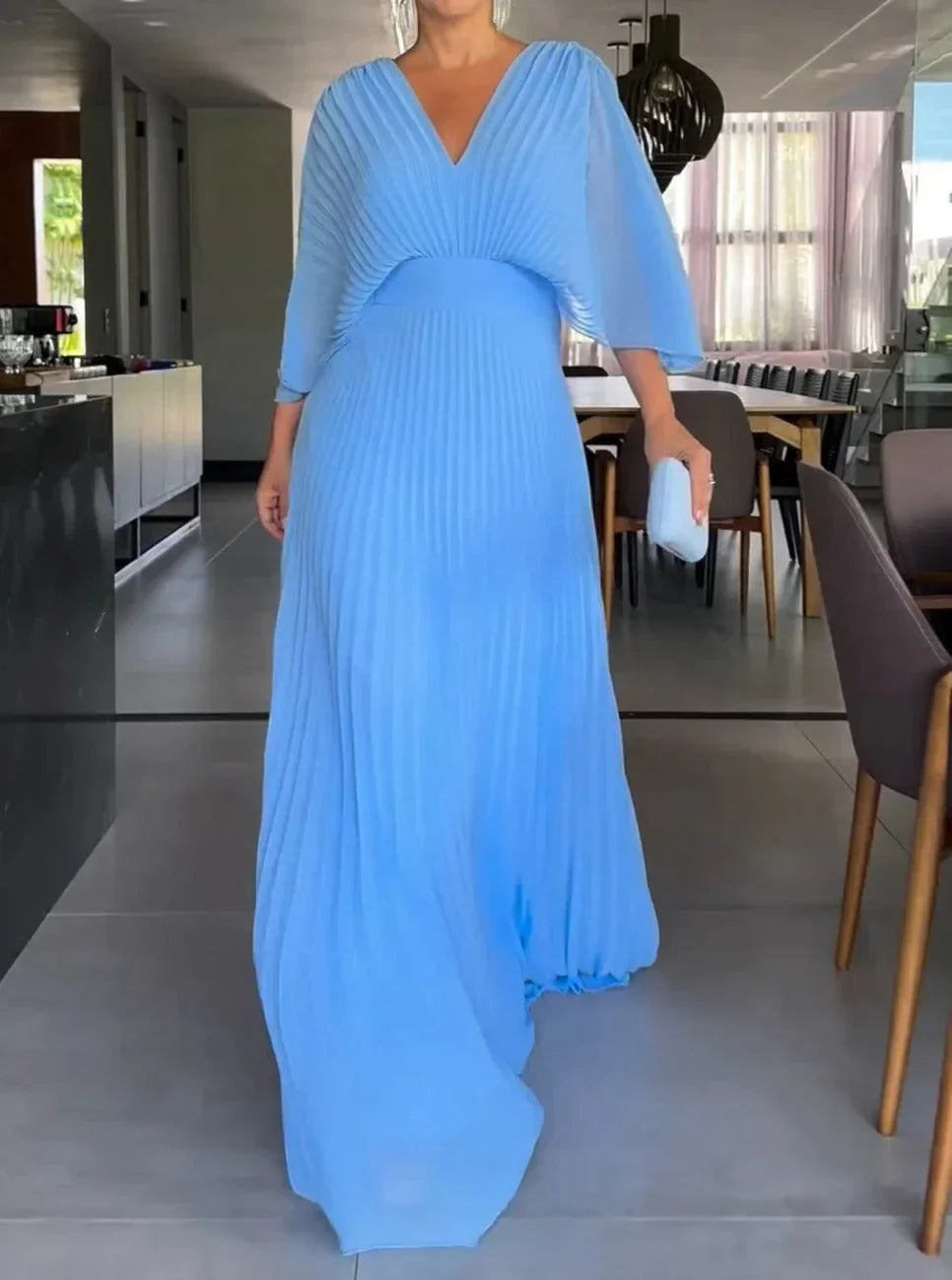 Flowy women's kaftan maxi dress with a V-neck and pleats, offering an elegant summer fashion statement.
