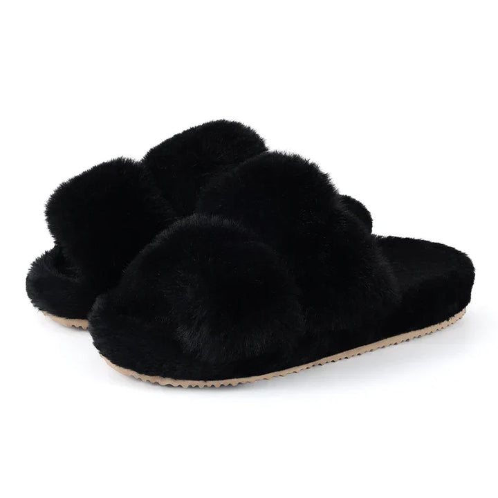 Pair of black faux fur slide slippers for women, showcasing their elegant design and comfort.