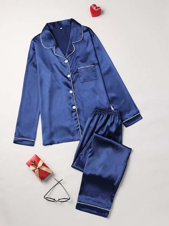Woman relaxing in a luxurious silky two-piece pajama set, perfect for comfortable sleepwear.