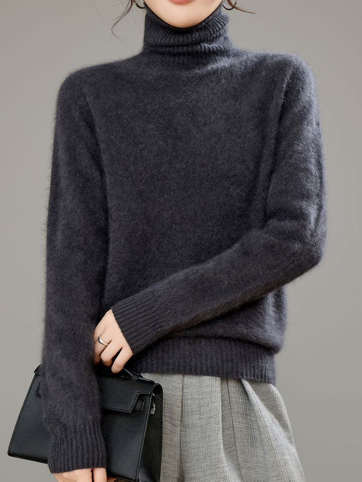 Full length view of a woman wearing a relaxed fit luxurious turtleneck sweater.