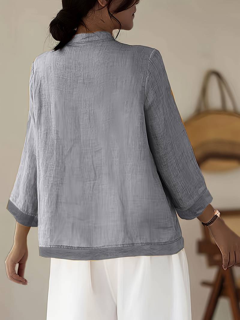 Full-length view of women's elegant mandarin collar frog button blouse, versatile.