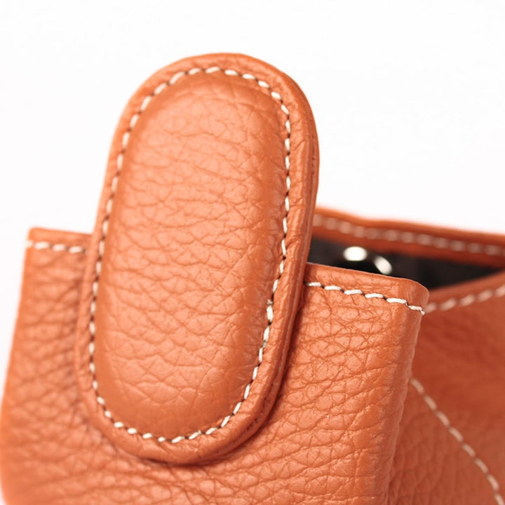 Close-up of the zipper on a mini black leather coin purse, showcasing quality