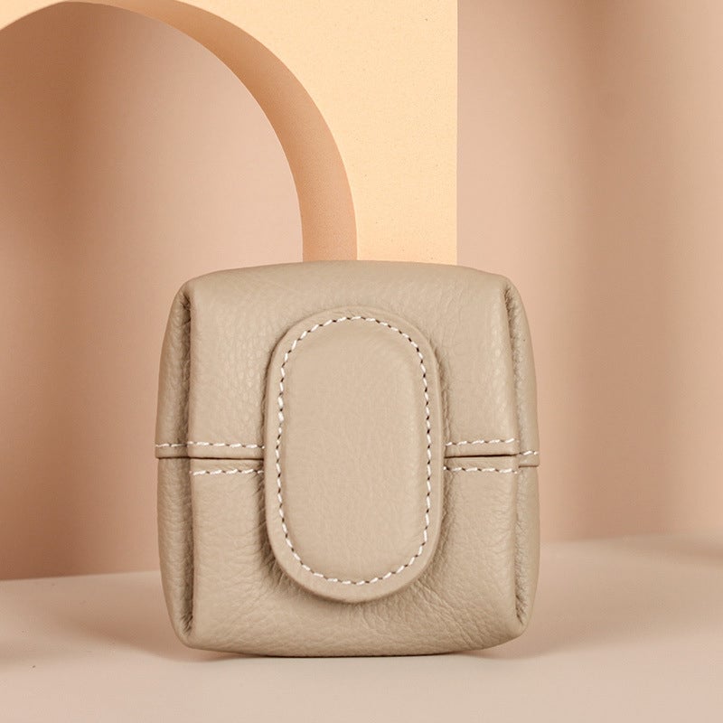 Front view of a sleek black women's mini leather coin purse, a timeless accessory