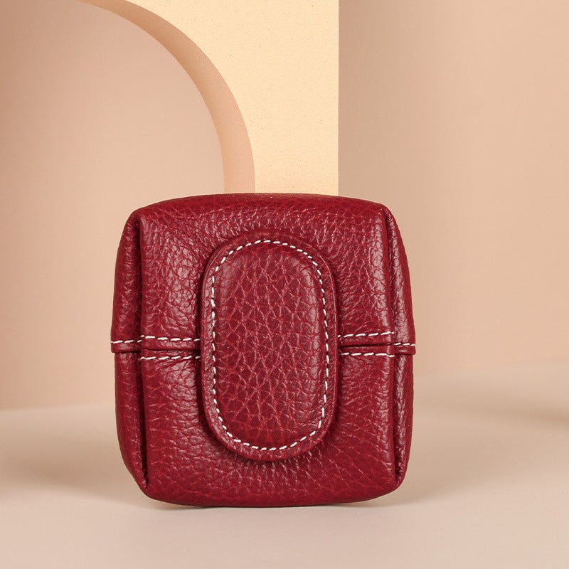 Close-up of a mini leather coin purse with an initial monogram, personalized gift