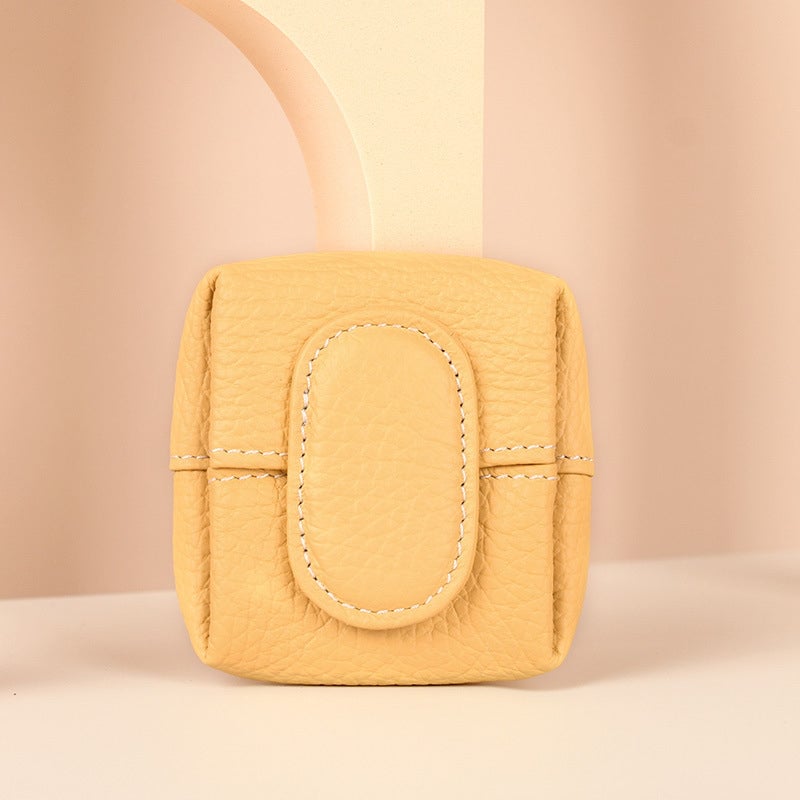 Elegant mini black leather coin purse displayed on a velvet surface, luxury appeal