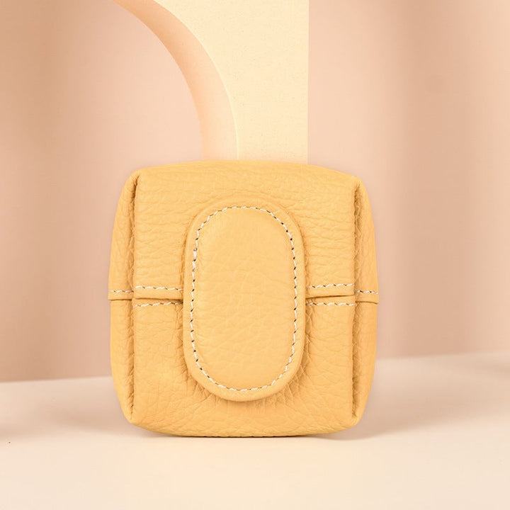 Elegant mini black leather coin purse displayed on a velvet surface, luxury appeal