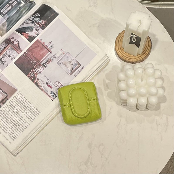 A gift box containing a mini red leather coin purse, perfect for a thoughtful present