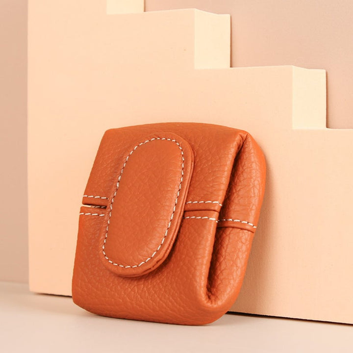 Classic tan leather coin purse with minimalist design, an essential everyday carry item
