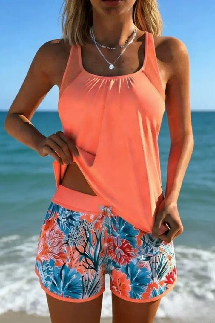 Women's flattering tankini swim set, ideal for summer fashion & coastal style. Vibrant print beachwear for women.