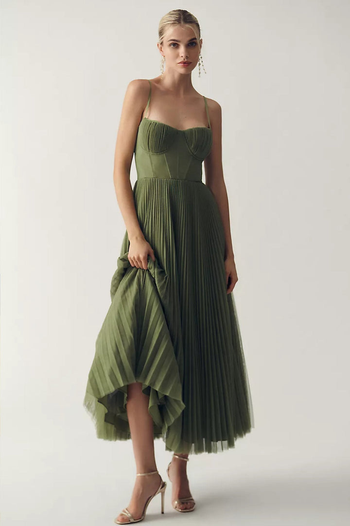 Women's one-shoulder flowing midi wedding guest dress in elegant pleated tulle. Perfect for formal occasions.