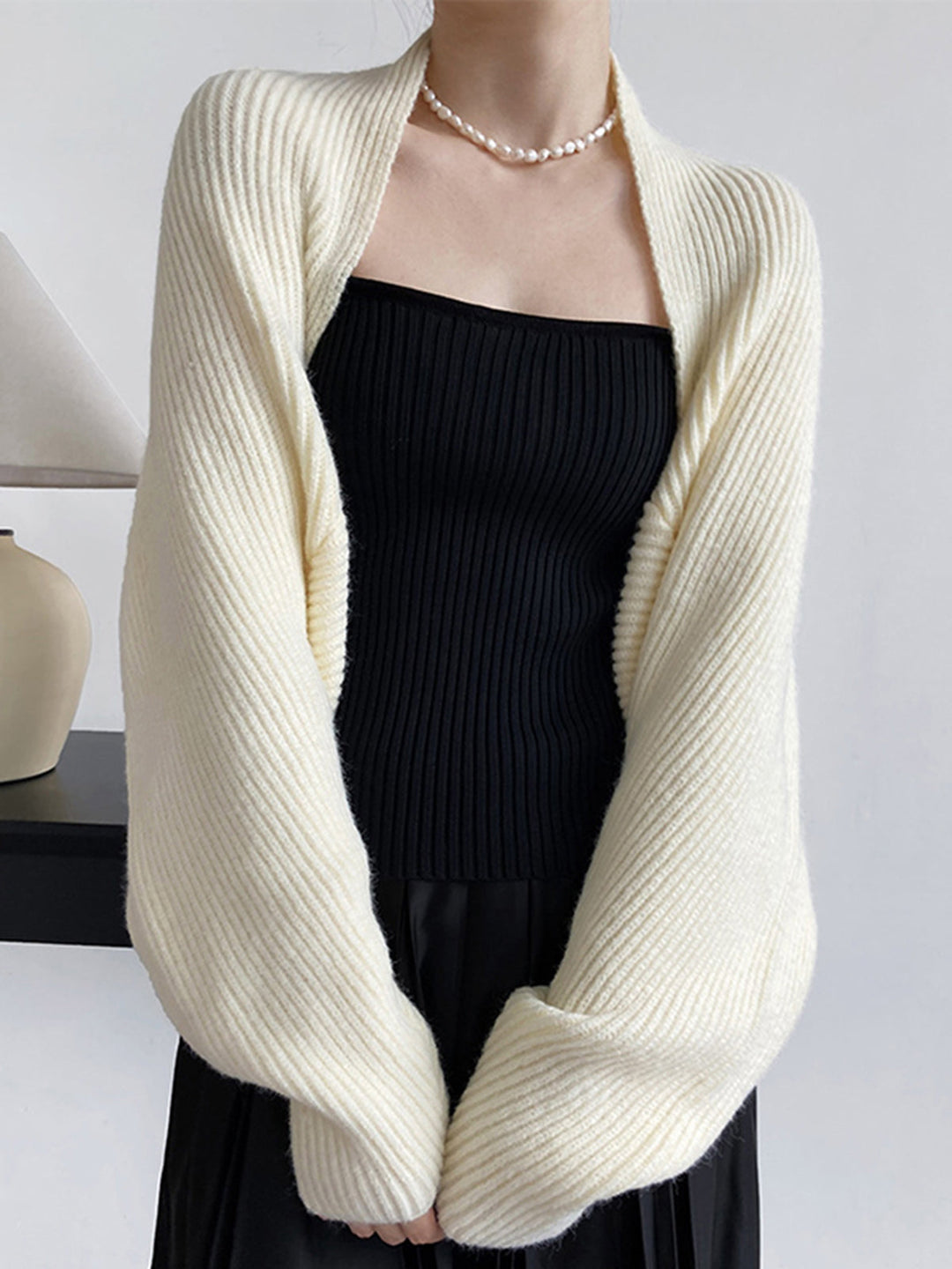 Full shot of women's open-front long sleeve shrug sweater, regular fit. Stylish and versatile cardigan.