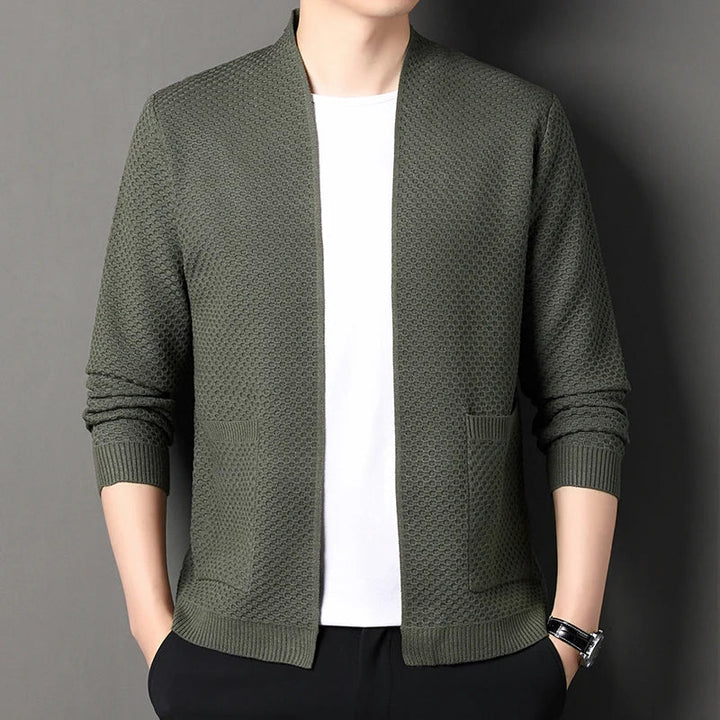 Folded women's knit cardigan ready for travel, emphasizing its midweight and layering appeal.