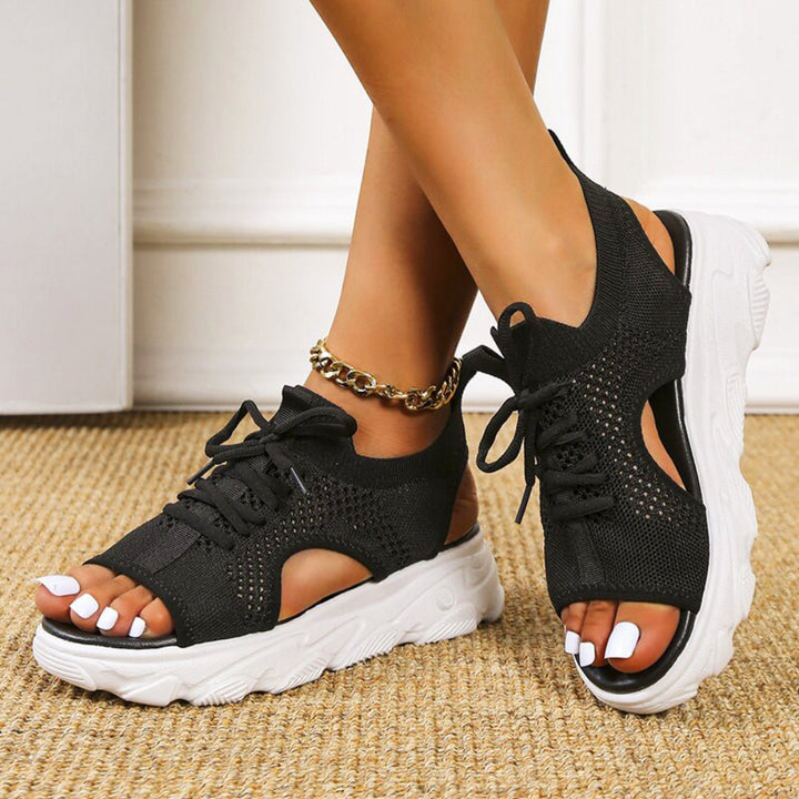 Trendy pink open-toe platform sandals for women, offering a stylish lace-up and comfortable fit.