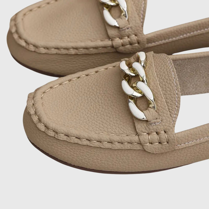 Pair of women's orthopedic loafers, showcasing their comfortable design & supportive sole.