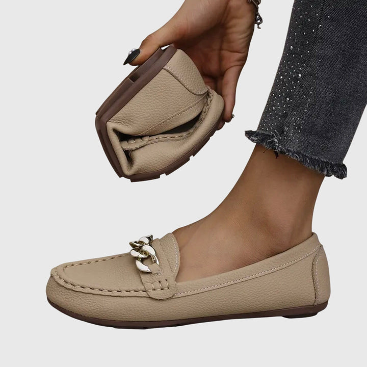 Woman wearing black orthopedic loafers, highlighting comfort & casual stylish look.