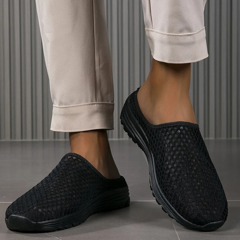 Breathable mesh slip-on women's sneakers, cushioned with orthopedic arch support for active comfort.