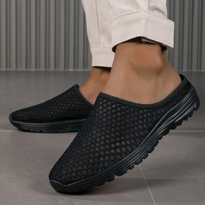 Comfortable women's slip-on sneakers with mesh upper, orthopedic design & arch support for all-day wear.