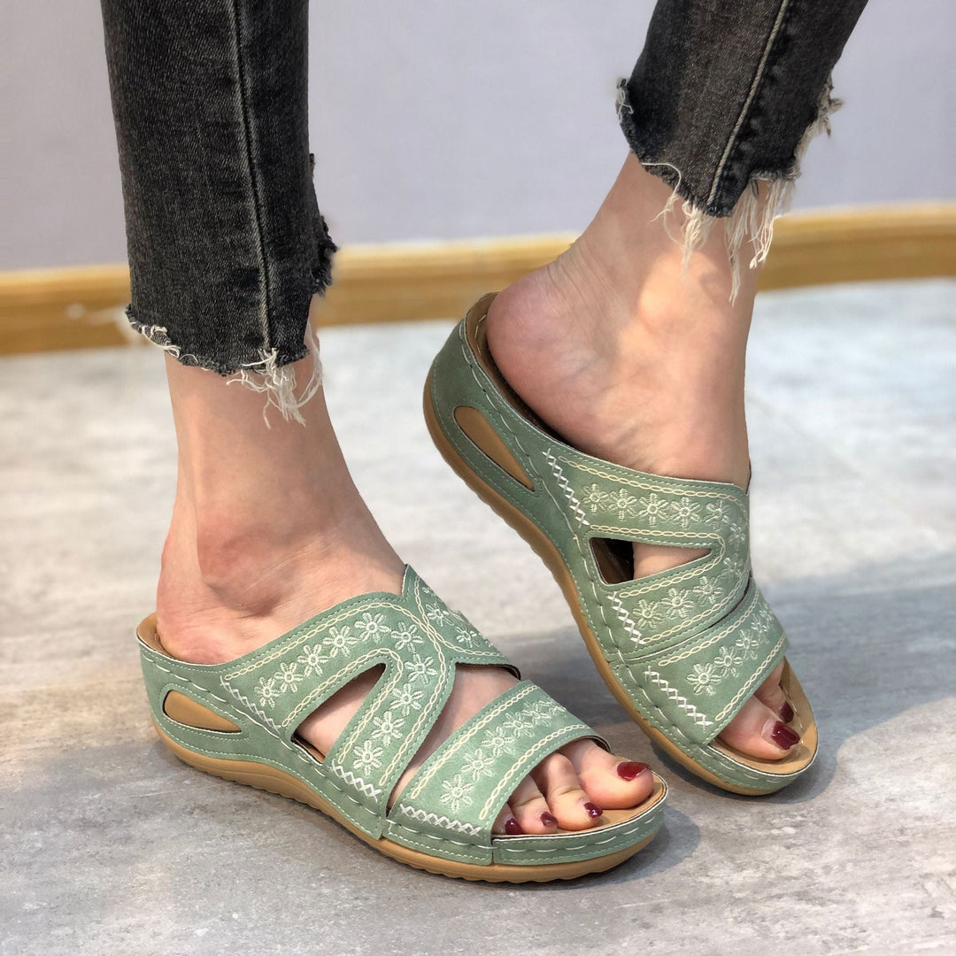 Side view of a women's supportive open-toe sandal, highlighting its contoured orthopedic sole for comfort.