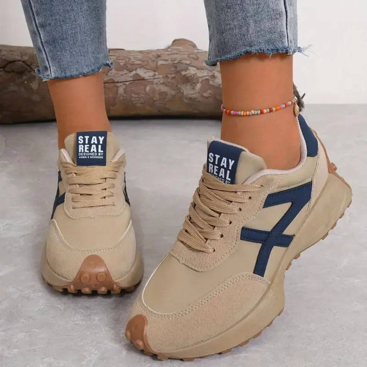 Comfortable women's walking sneakers with orthopedic support, featuring a stylish panel design & secure lace-up closure.