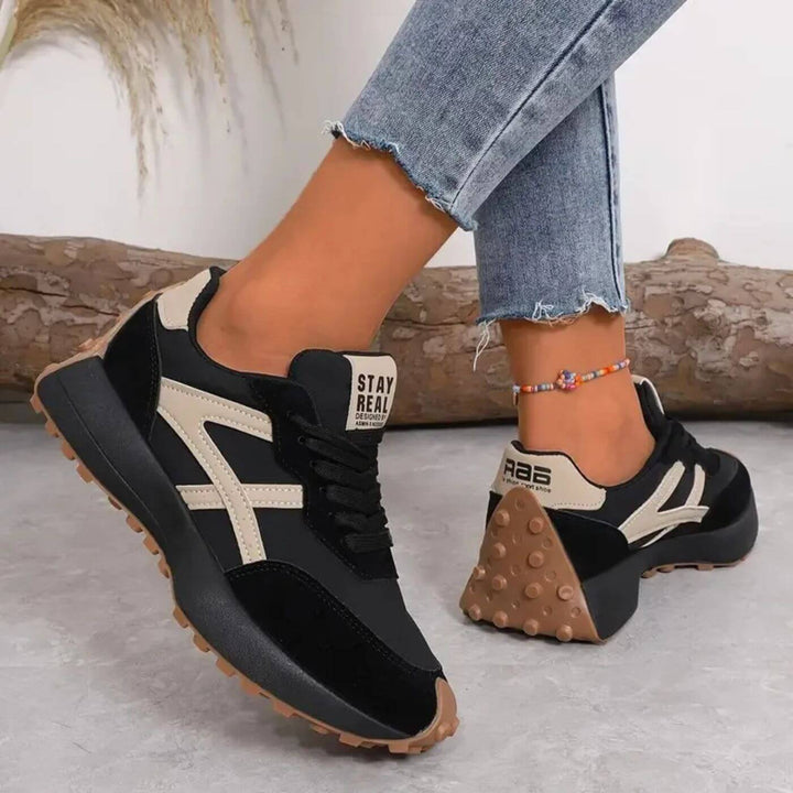 Women's lace-up orthopedic sneakers, featuring a unique panel design, platform sole, & superior comfort for daily walks.