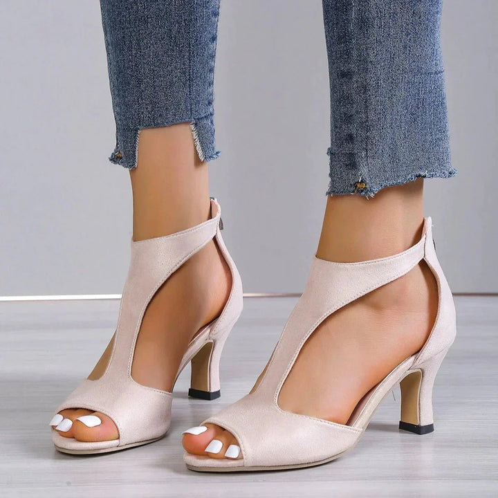Stylish women's T-strap high heels featuring a peep toe design and orthopedic footbed for ultimate comfort.