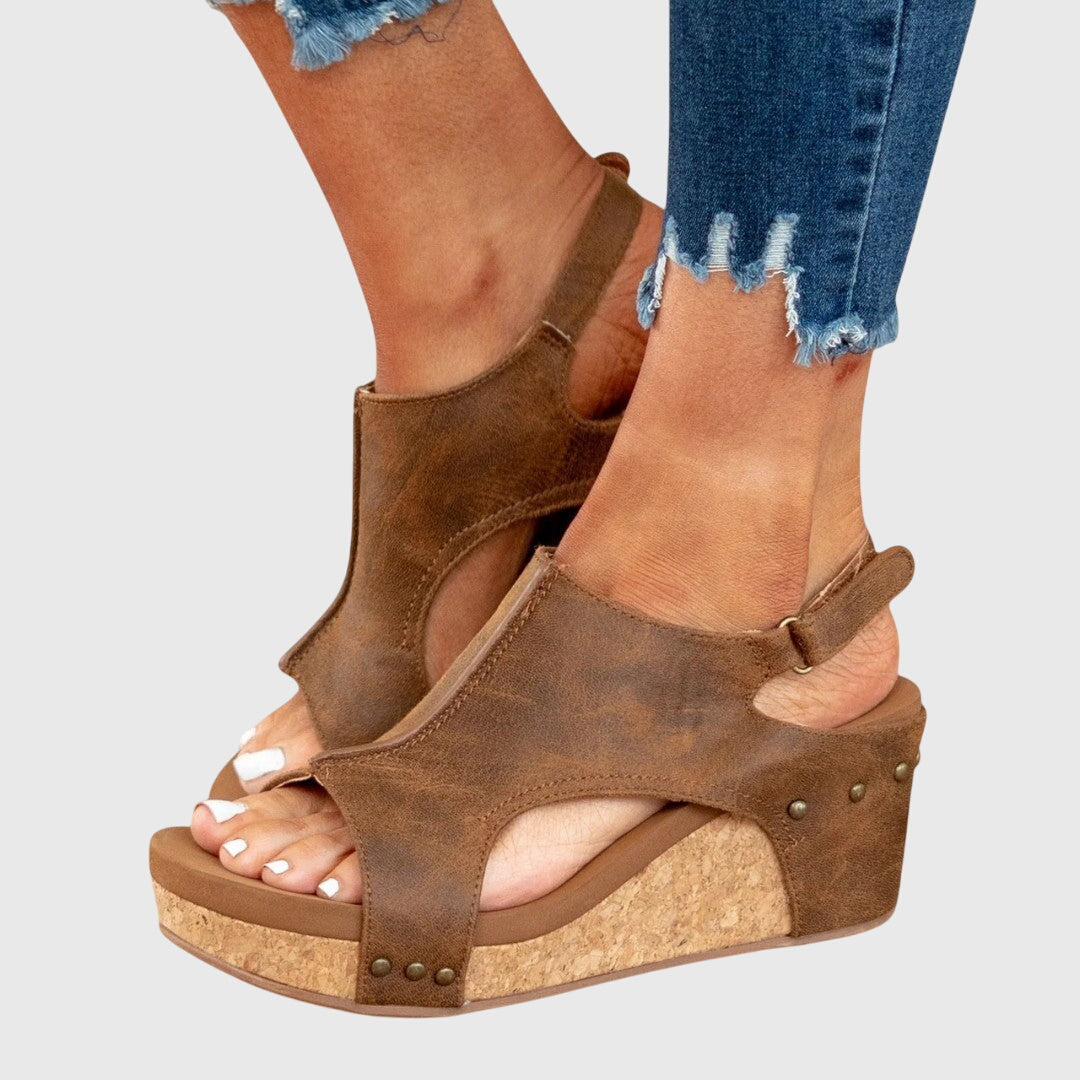 Elegant women's sandals with a subtle wedge, offering stylish arch support and comfort.