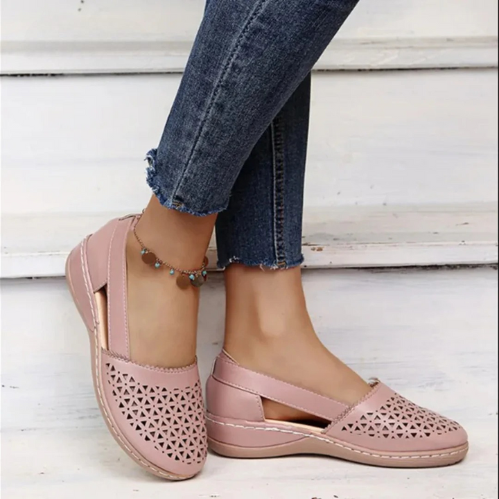 Stylish women's slip-on flats with cutout design, orthopedic support for all-day comfort.