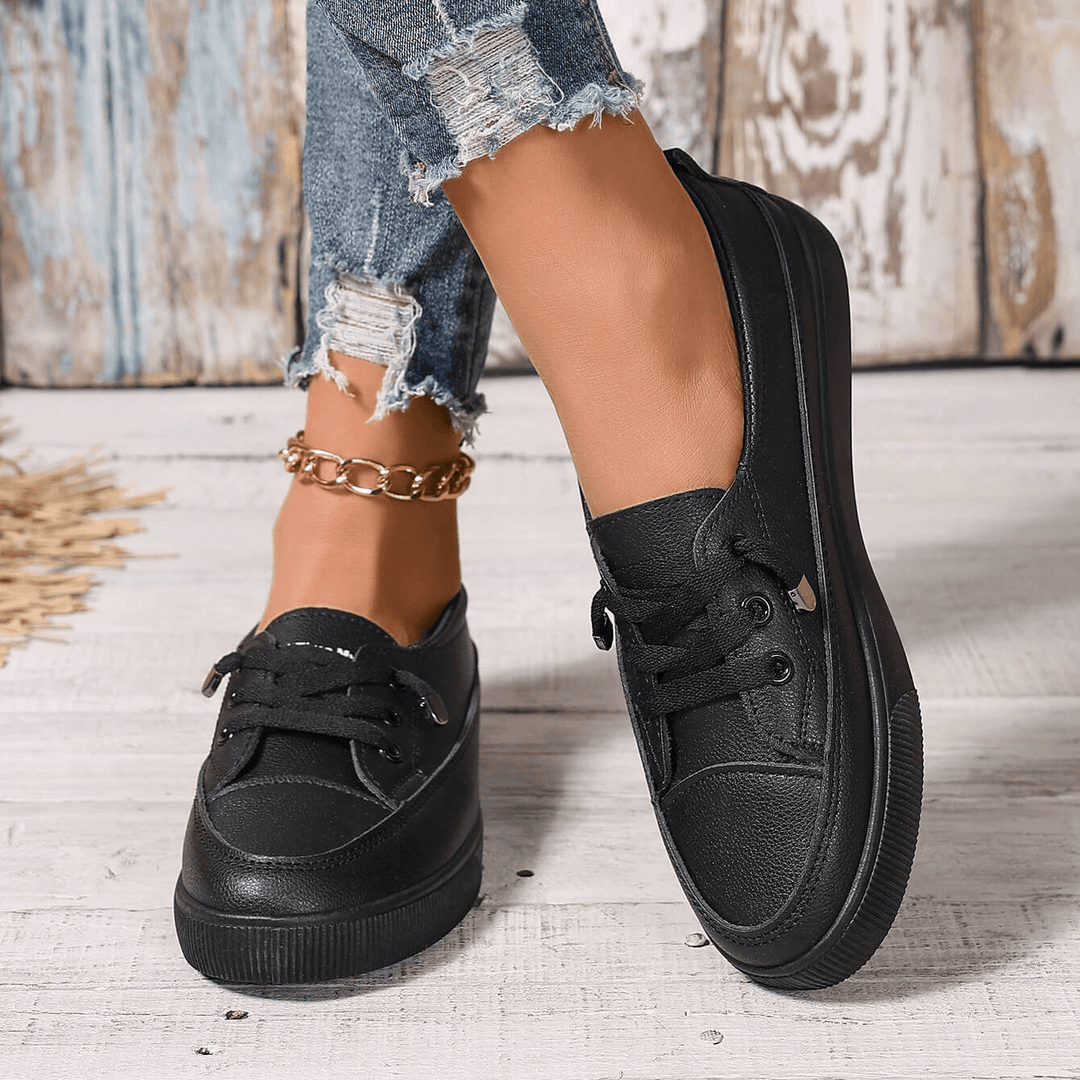 Side view of women's comfortable orthopedic sneakers, showcasing arch support & sleek design.