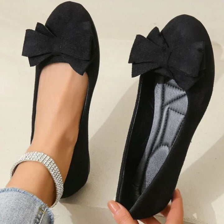Stylish women's wide fit ballet flats offering orthopedic support for all-day comfort.