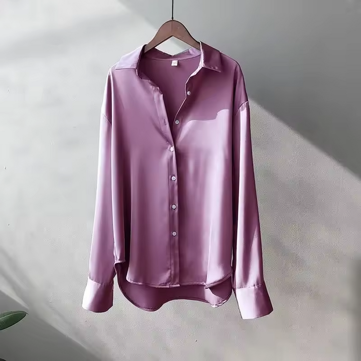 Fashion-forward women's oversized button down blouse. Long sleeve, relaxed silhouette, an elegant statement piece.
