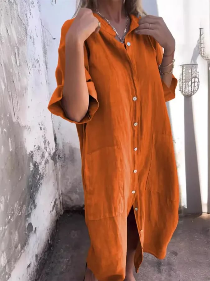 Women's elegant oversized button down midi dress with practical pockets and versatile roll-tab sleeves.