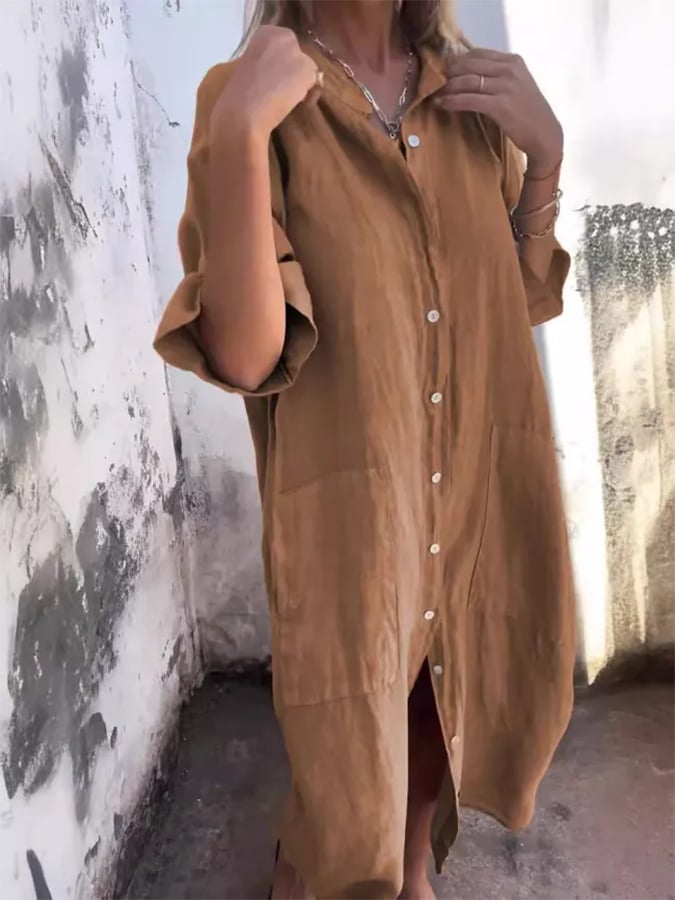 Women's casual oversized midi dress featuring a button down front, pockets, and roll tab sleeves for summer.