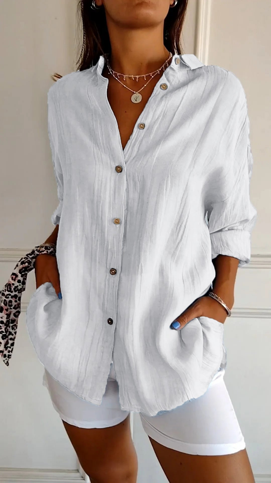 Women's summer top, oversized button-down shirt with long sleeves, a versatile and relaxed fit essential.