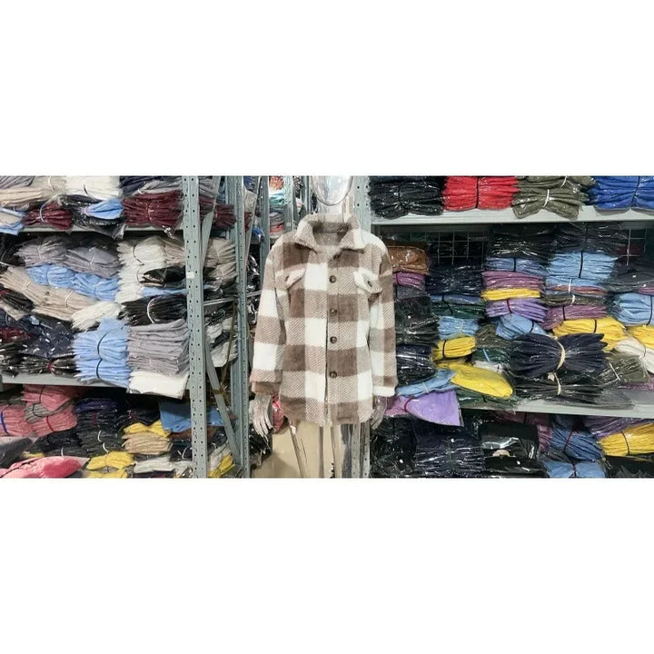 Button-up women's oversized fleece plaid shacket, a versatile top for any occasion.