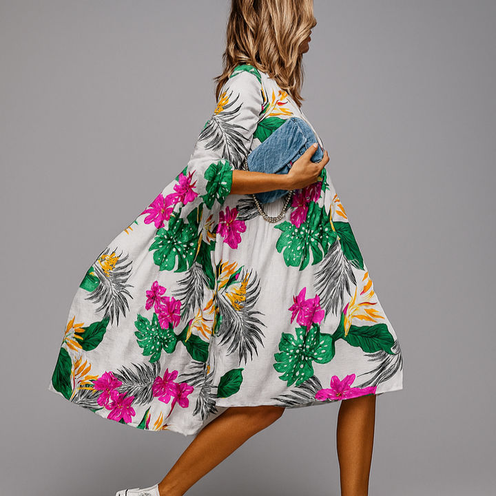 Elegant women's midi dress with a colorful floral print, oversized relaxed fit, and stylish puff sleeves.
