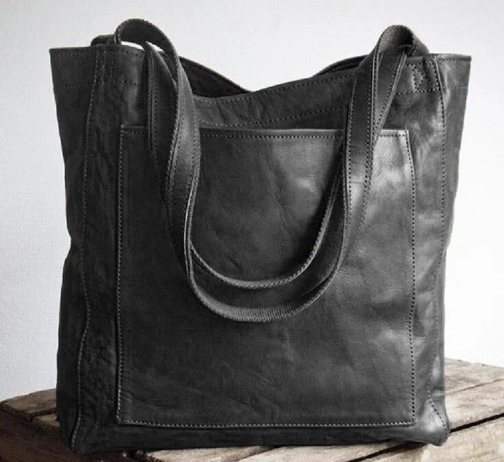 Luxurious grain leather shoulder bag for women, an oversized tote with a prominent external pocket.
