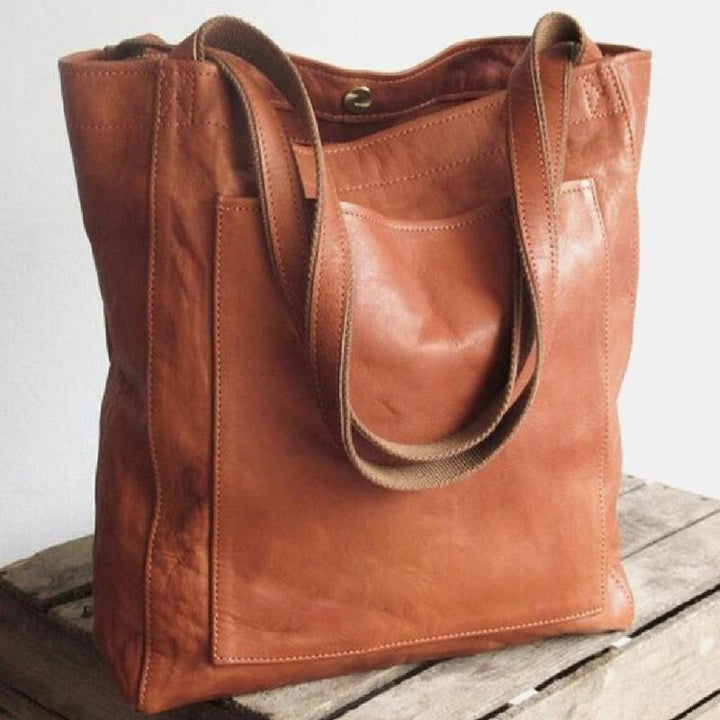 Spacious women's grain leather tote, an oversized handbag with practical large external pocket for essentials.