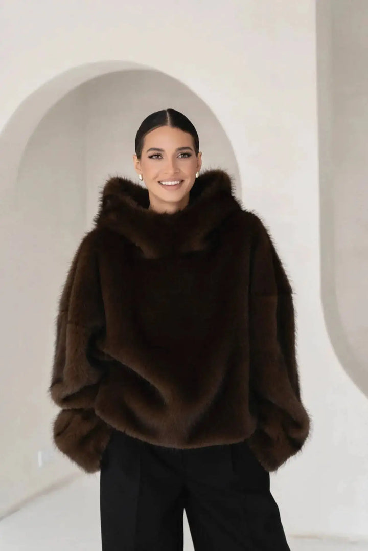 Warm women's oversized plush hoodie pullover with drop shoulder design. A cozy top for stylish winter loungewear.