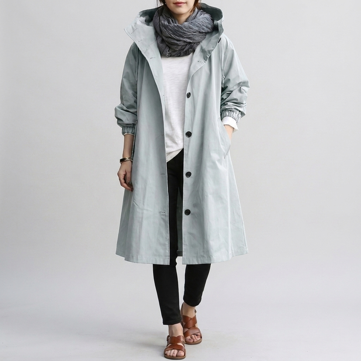 Woman enjoying outdoors in a fashionable oversized rain jacket, providing waterproof comfort & style.