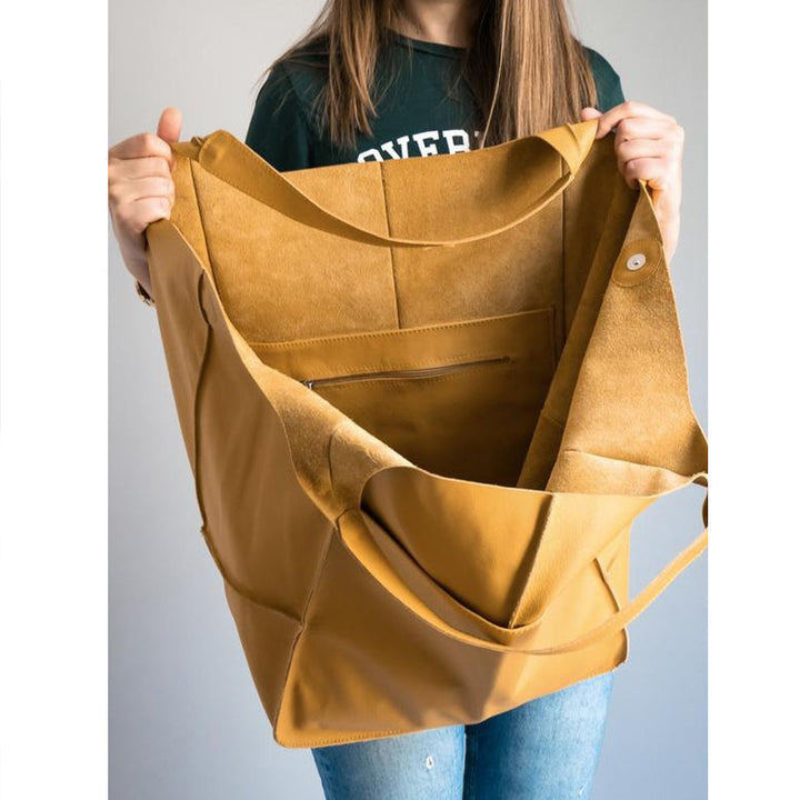 Trendy women's vintage style leather bag, oversized for comfortable shoulder carry.