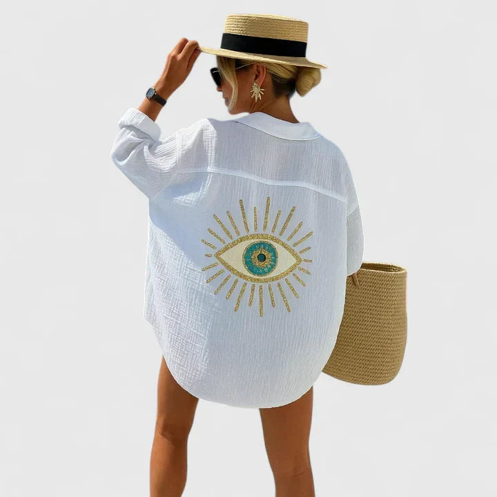 Embroidered women's oversized button-down beach shirt. Stylish evil eye cover-up for vacation or casual summer wear.