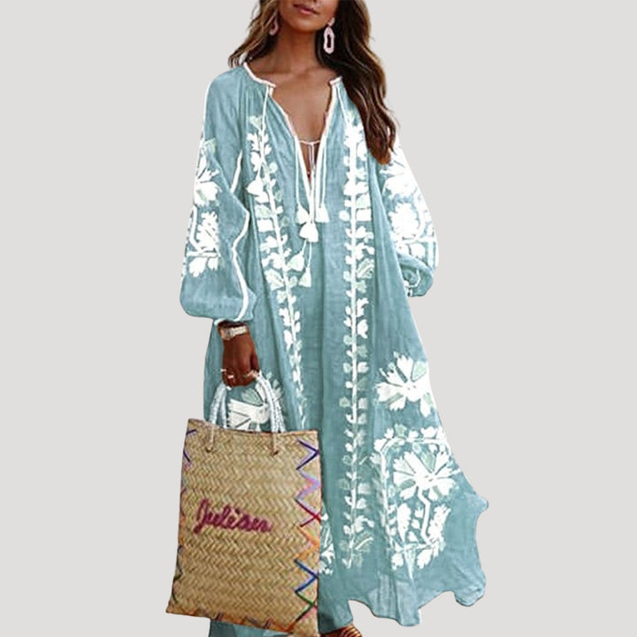 Detailed view of a loose-fit women's patterned maxi dress with a V-neck and elegant long sleeves.