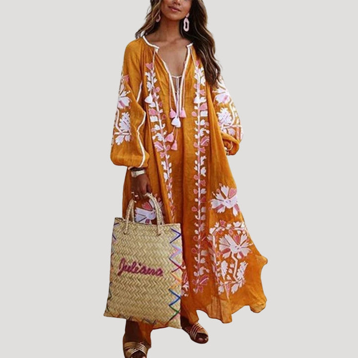 Stylish women's long sleeve boho maxi dress, featuring a vibrant all-over pattern and V-neckline.