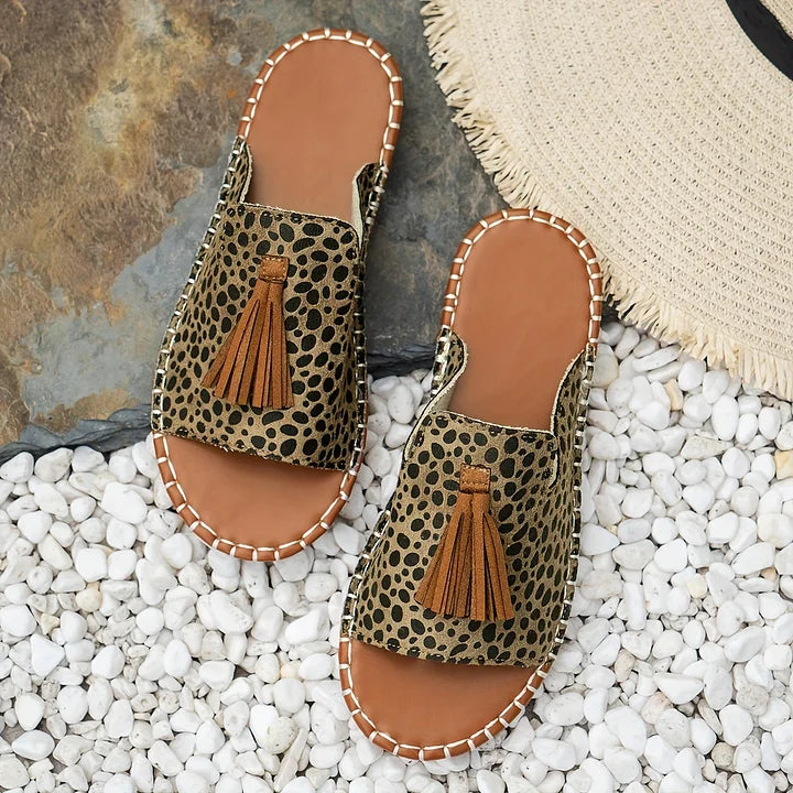 Soft and comfortable women's patterned open toe tassel slide sandals. Flat sole, perfect for summer casual wear.